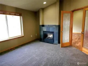 2 way fireplace and French door open to a dining room or an additional living space