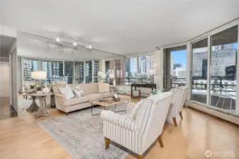 An expansive living room featuring classic hardwood floors throughout.