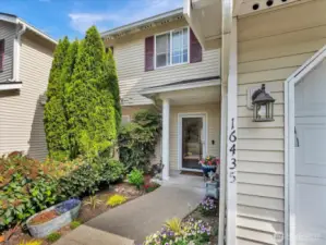 Closer front photo with colorful landscaping.