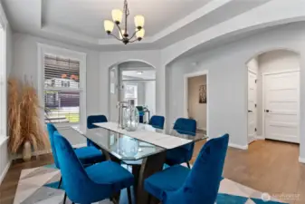Another view from the dining room. From left to right are the front door, den/office, powder room, coat closet and garage door.
