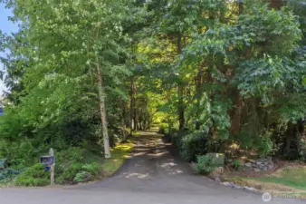 The tree-lined driveway guides you to the home set well back from the street, in a peaceful and secluded setting surrounded by mature landscaping and natural beauty.