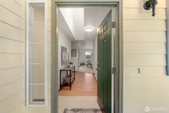 Warm, natural light filters through a skylight that opens & is screened, creating an inviting atmosphere as you come home.