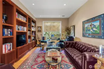 The library/office is just off of the kitchen- features beautiful shelves and elegant appointments. This could also be a fourth bedroom.