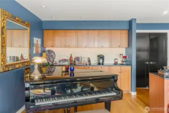 The family room boasts a very discreet kitchen- complete with  refrigerator, freezer, sink and dishwasher. Perfect for easy access to snacks while watching a game.