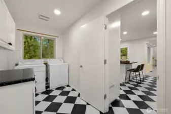 Laundry room is situated between kitchen and garage