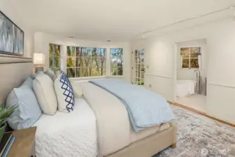 This palatial primary bedroom has space for everything, plus a walk-in closet!