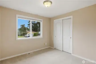 Bedroom or home office with natural light and closet.