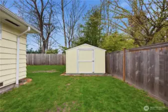 Large storage shed has multiple uses. Level side yard.