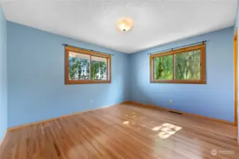 Primary bedroom with gorgeous wood floors.