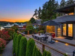 Evening view of your large entertainment deck. Enjoy dining al fresco in this lush garden.