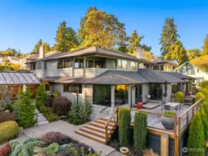 All day sun with the southern exposure. Covered patio on the left. Large entertainment deck on the right. Primary bedroom covered balcony in the center. Rooftop deck visible above right.