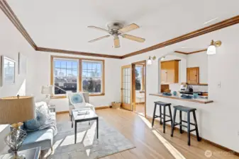 Perched on the top floor, this sun-drenched living room is your private retreat in the sky. Original leaded glass windows frame captivating cityscapes and golden sunsets, filling the space with warmth and timeless charm.