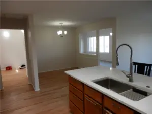 Entry is to the left which comes into the kitchen, dining room and family room areas.