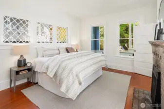 Generous main floor bedroom with period fireplace.