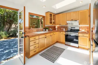 New appliances in the eat in kitchen with French doors leading to the rear garden and raised deck.