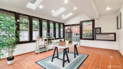 A versatile sunroom filled with natural light—ideal as a lounge, creative studio, or indoor garden.
