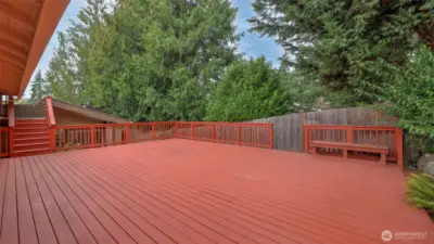 Step out to this spacious deck surrounded by mature greenery.