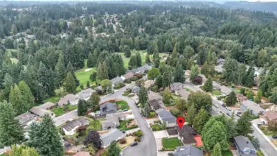 Nestled in a quiet cul-de-sac, this home offers both privacy and a peaceful setting surrounded by lush greenery.