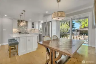 Sliding glass door with internal blinds opens to the backyard, adding light and easy indoor-outdoor flow.