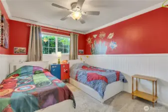 Cheerful bedroom with wainscoting detail and new carpet.