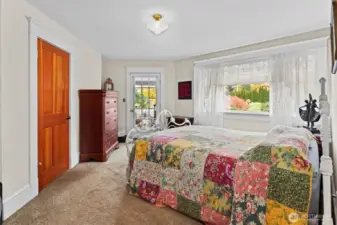 Primary bedroom with door to covered sitting area.