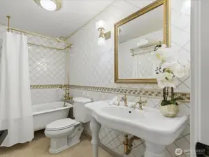 Guest bath with floor-to-ceiling tile, and clawfoot tub!