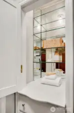 Light up and mirrored cabinet in bathroom.