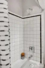 Shower with tile surround.