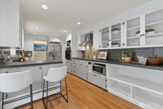 This thoughtful kitchen features an induction cooktop backdropped by gorgeous imported hand-made tiles from Lisbon.