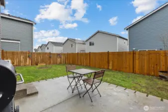 Backyard featuring new fencing and patio.