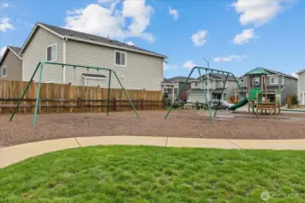 Large playground area with house located in the background.