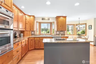 Ample storage throughout kitchen w/solid hickory cabinets, granite counters, full height tile backsplash & stainless steel appliances