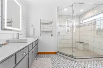 Ensuite bath freshly remodeled in 2021 w/beautiful tile flooring, quartz countertops, ginormous walk-in custom shower heated towel warmer & more!