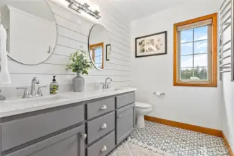 Full size bathroom upstairs also remodeled in 2021 with tile flooring, quartz countertops, dual vanity, lovely shiplap wall. Includes tub/shower & large linen closet