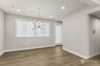 Virtual staging.  Light and bright and just off the kitchen and next to the covered deck.