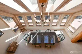 Bright dinning area with windows and skylights