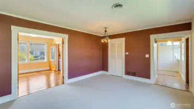 Upstairs: Living room, looking back towards entrance and into primary bedroom.