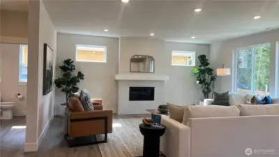 Oversized great room, perfect for large gatherings.  Plentiful number of large windows for that wonderful added natural lighting.  Gas fireplace and textured tiled surround.  Powder bath on main with cabinet/sink.