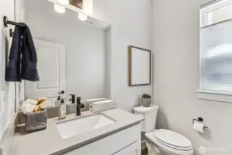 1/2 bath w/quartz counter on main level.