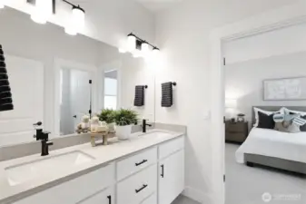 Upstairs bath with separate area for the tub/shower/toilet.  Dual sinks, qtz countertops, tile floor and black hardware throughout.