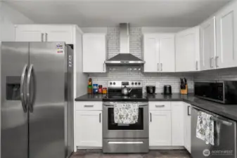 White and bright kitchen with newer appliances.