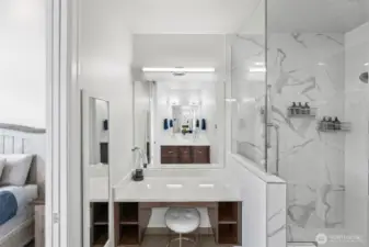 Separate vanity space in the primary bathroom. It has its own lighting and nice storage.