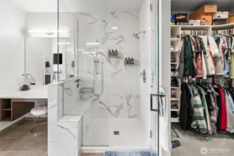 Gorgeous primary shower with built-in bench. Two show heads and easy-to-maintain tile surround.