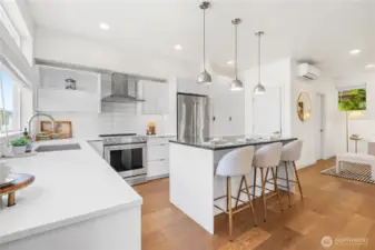 Modern kitchen with high-end appliances and lighting fixtures.