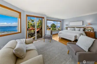 Primary bedroom has sweeping views and space for both a king bed and separate seating area.