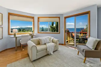 Primary bedroom has sweeping views and space for both a king bed and separate seating area.