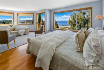 Primary bedroom has sweeping views and space for both a king bed and separate seating area.