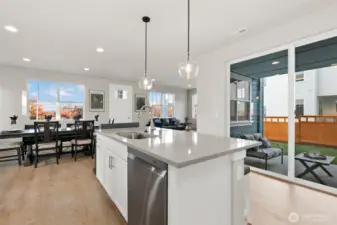 Picture is of a similar home. Different angle of the kitchen with a outside covered patio