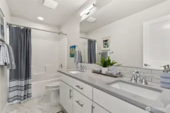 Picture of a similar home. Secondary bath, two undermounted vanity sinks + tub/shower.