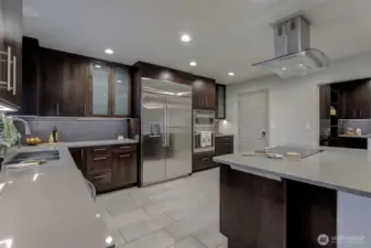 Oversized fridge and generous cabinets and counter space.  A peek into the walk in pantry